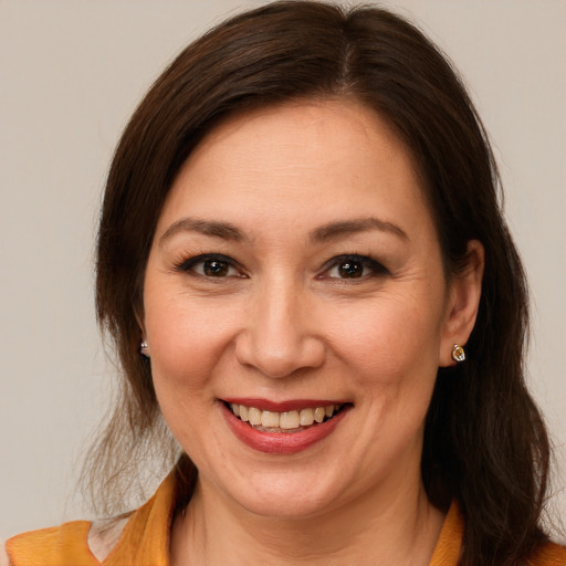 Joyful white young-adult female with medium  brown hair and brown eyes