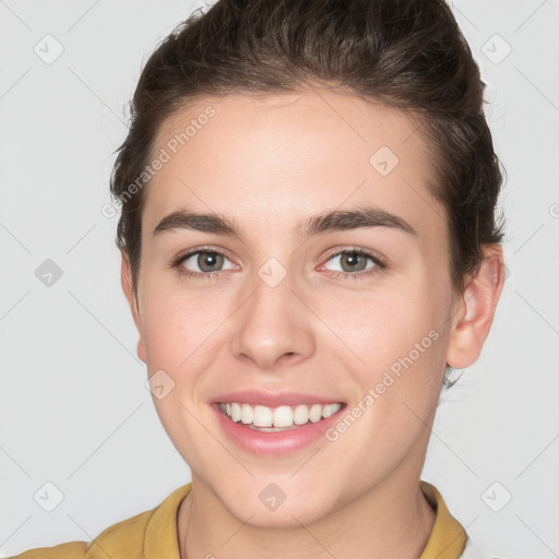 Joyful white young-adult female with short  brown hair and brown eyes