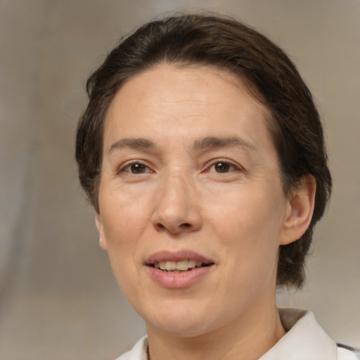 Joyful white adult female with medium  brown hair and brown eyes