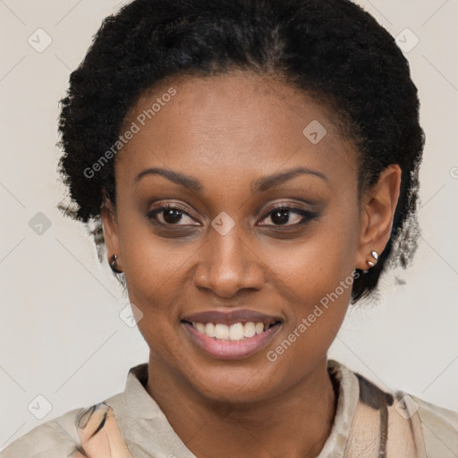 Joyful black young-adult female with short  black hair and brown eyes