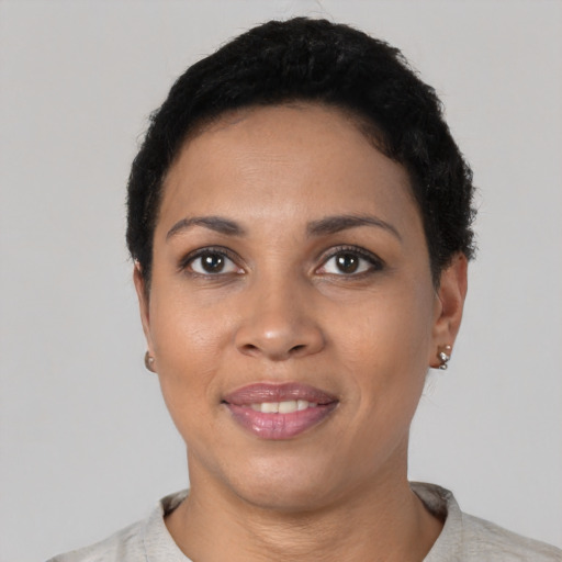 Joyful latino young-adult female with short  black hair and brown eyes
