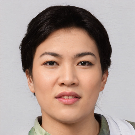 Joyful asian young-adult female with medium  black hair and brown eyes