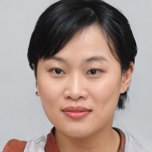 Joyful asian young-adult female with medium  black hair and brown eyes