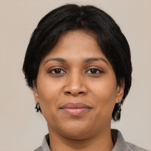 Joyful black young-adult female with medium  black hair and brown eyes