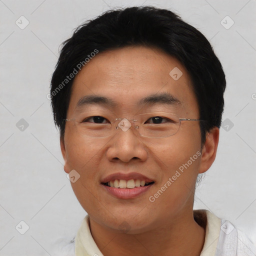 Joyful asian young-adult male with short  black hair and brown eyes