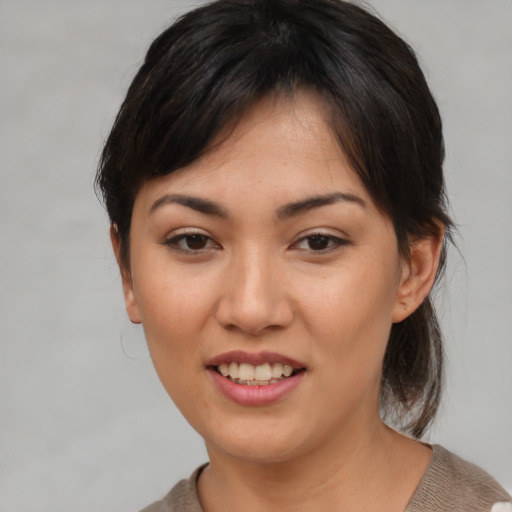 Joyful asian young-adult female with medium  brown hair and brown eyes