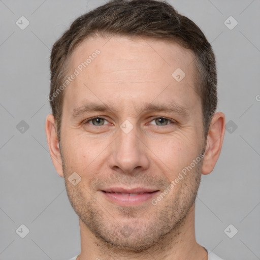 Joyful white adult male with short  brown hair and brown eyes