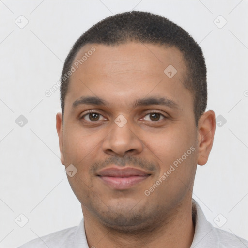 Joyful latino young-adult male with short  brown hair and brown eyes
