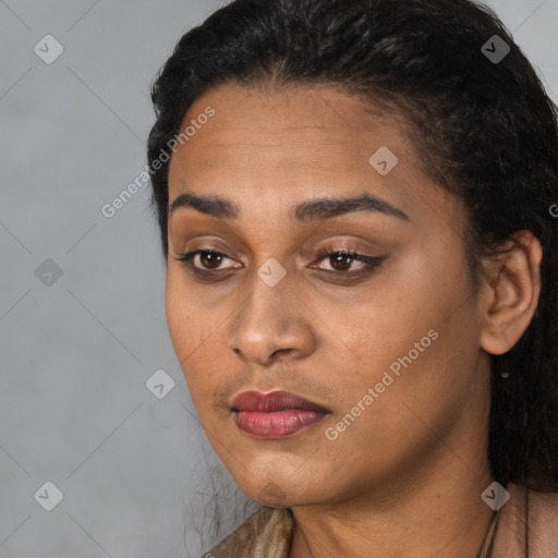 Joyful black young-adult female with long  black hair and brown eyes