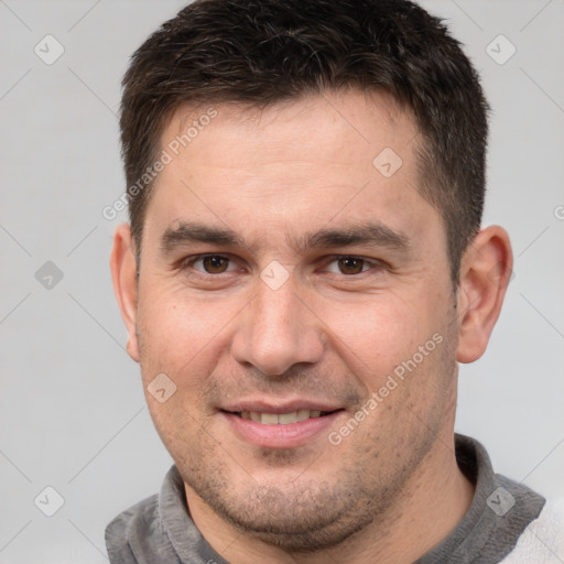 Joyful white adult male with short  brown hair and brown eyes