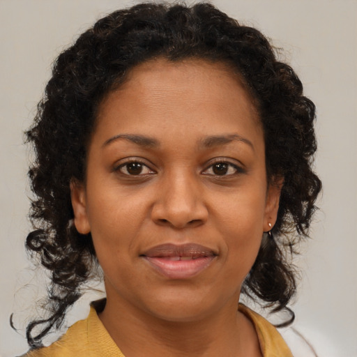 Joyful black young-adult female with medium  brown hair and brown eyes