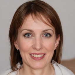 Joyful white young-adult female with medium  brown hair and blue eyes