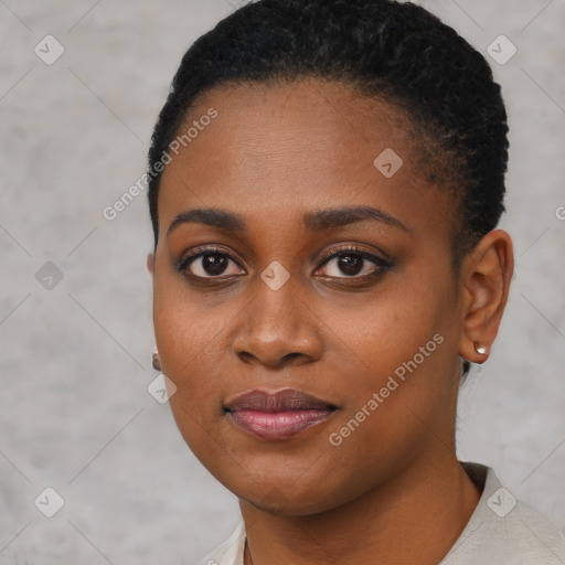 Joyful black young-adult female with short  black hair and brown eyes