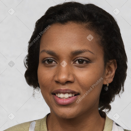 Joyful black young-adult female with short  black hair and brown eyes