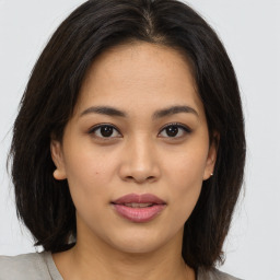 Joyful asian young-adult female with medium  brown hair and brown eyes