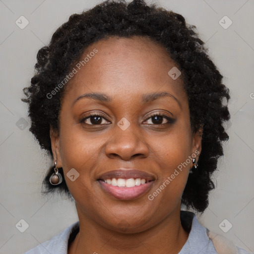 Joyful black young-adult female with long  brown hair and brown eyes