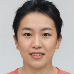 Joyful asian young-adult female with short  brown hair and brown eyes