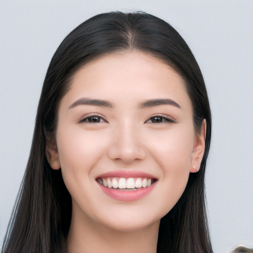 Joyful white young-adult female with long  black hair and brown eyes