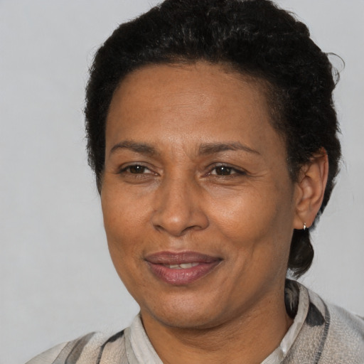 Joyful latino adult female with short  black hair and brown eyes