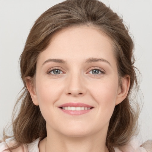 Joyful white young-adult female with medium  brown hair and grey eyes