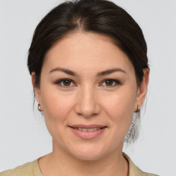 Joyful white adult female with medium  brown hair and brown eyes