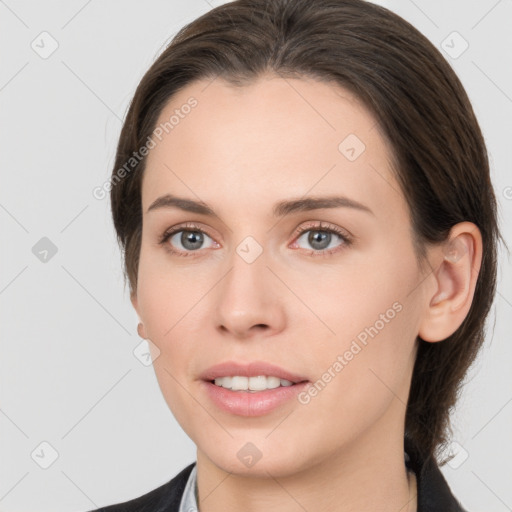 Joyful white young-adult female with medium  brown hair and grey eyes