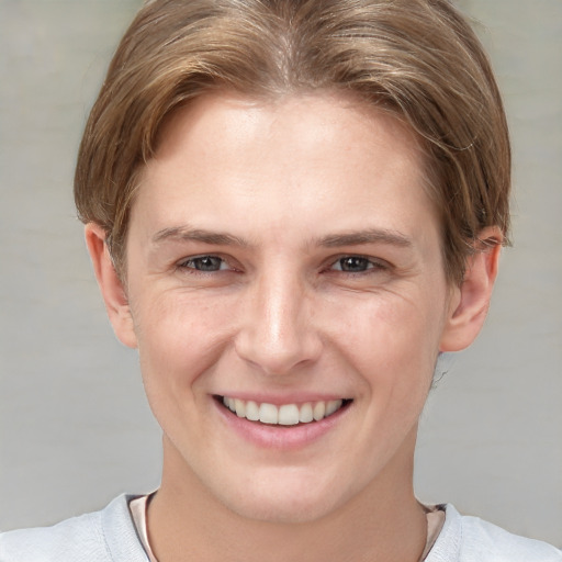 Joyful white young-adult female with short  brown hair and grey eyes