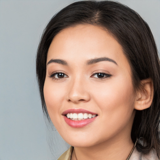 Joyful white young-adult female with long  brown hair and brown eyes