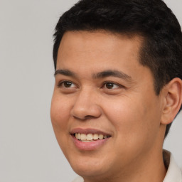 Joyful latino young-adult male with short  brown hair and brown eyes