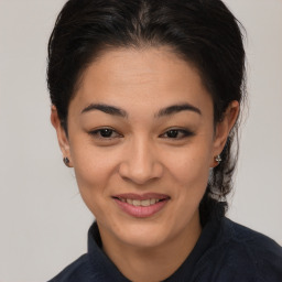 Joyful asian young-adult female with medium  brown hair and brown eyes