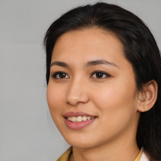 Joyful asian young-adult female with long  brown hair and brown eyes