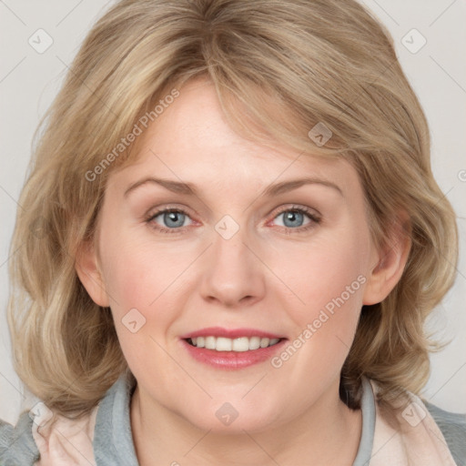 Joyful white adult female with medium  brown hair and blue eyes