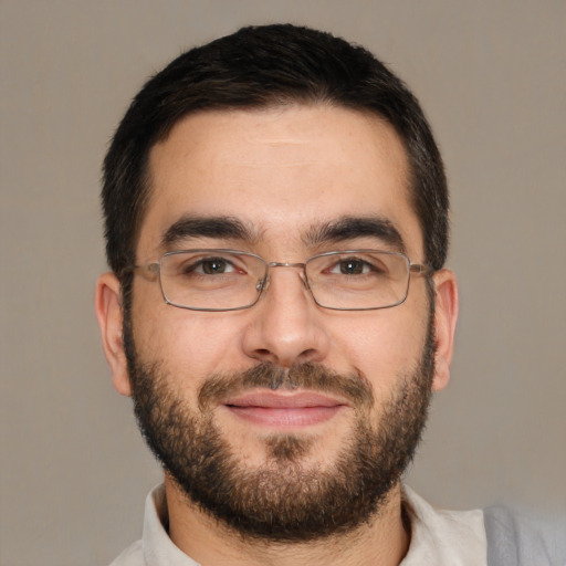 Joyful white adult male with short  black hair and brown eyes