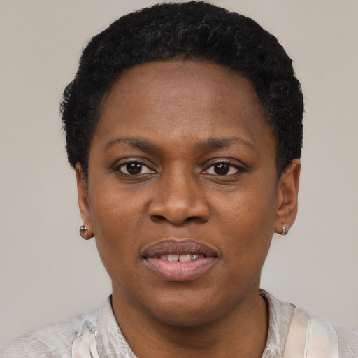Joyful black young-adult female with short  black hair and brown eyes