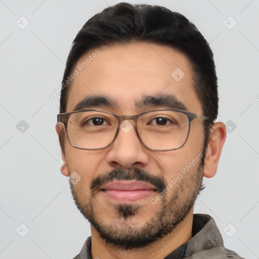 Joyful white young-adult male with short  black hair and brown eyes