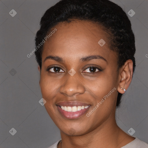 Joyful black young-adult female with short  black hair and brown eyes