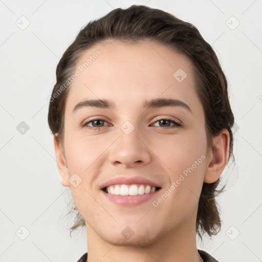 Joyful white young-adult female with short  brown hair and brown eyes