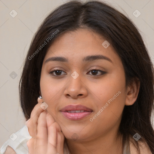 Joyful latino young-adult female with long  brown hair and brown eyes