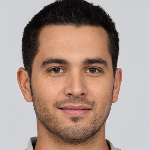 Joyful white young-adult male with short  brown hair and brown eyes