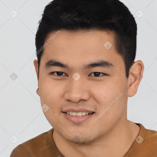 Joyful asian young-adult male with short  black hair and brown eyes