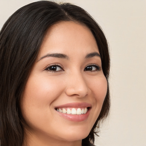 Joyful white young-adult female with long  brown hair and brown eyes