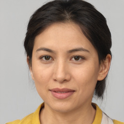 Joyful asian adult female with medium  brown hair and brown eyes