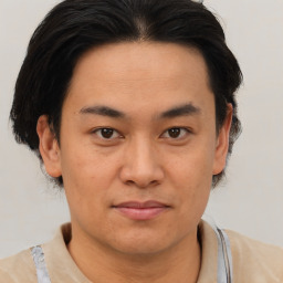 Joyful asian young-adult male with short  brown hair and brown eyes