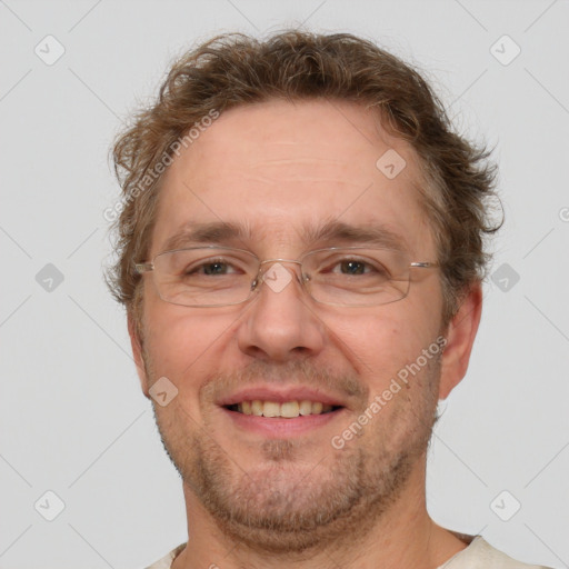 Joyful white adult male with short  brown hair and grey eyes