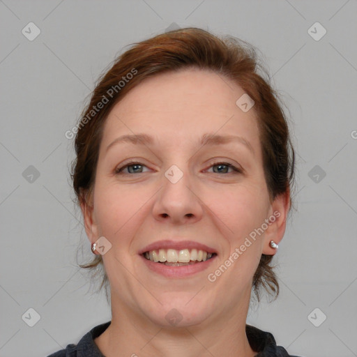 Joyful white adult female with medium  brown hair and blue eyes