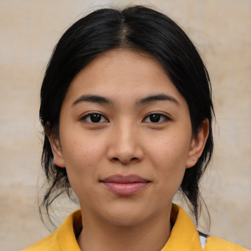 Joyful latino young-adult female with medium  black hair and brown eyes