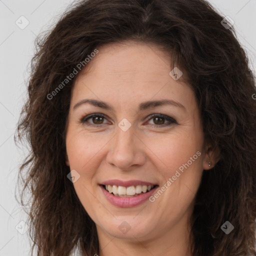 Joyful white adult female with long  brown hair and brown eyes