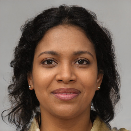 Joyful black young-adult female with medium  brown hair and brown eyes