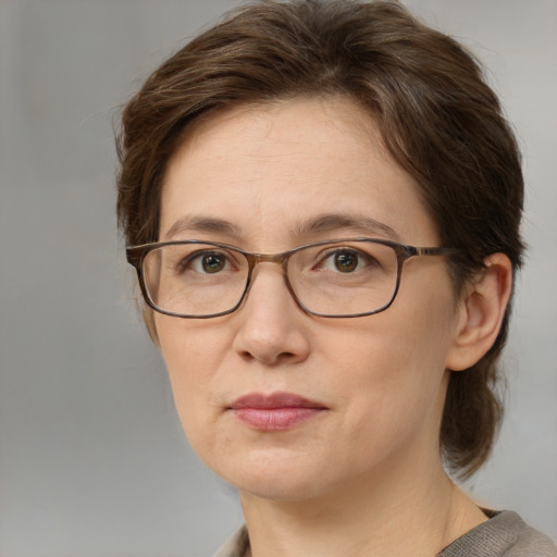 Joyful white adult female with medium  brown hair and grey eyes