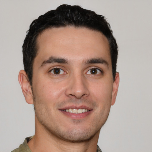 Joyful white young-adult male with short  brown hair and brown eyes